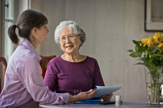 Elderly woman speaking with her doctor.