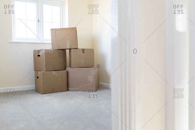 Cardboard boxes in an empty room in a new home