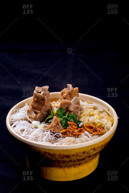 Warm bowl of ribs with noodles
