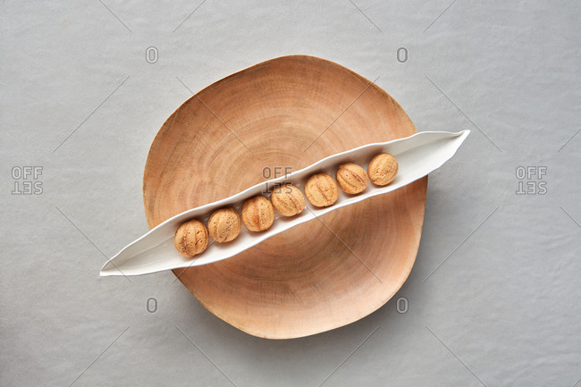 Baking composition with homemade delicious freshly baked cookies in the shape of walnuts on a wooden plate and gray background, place for text. Flat lay.