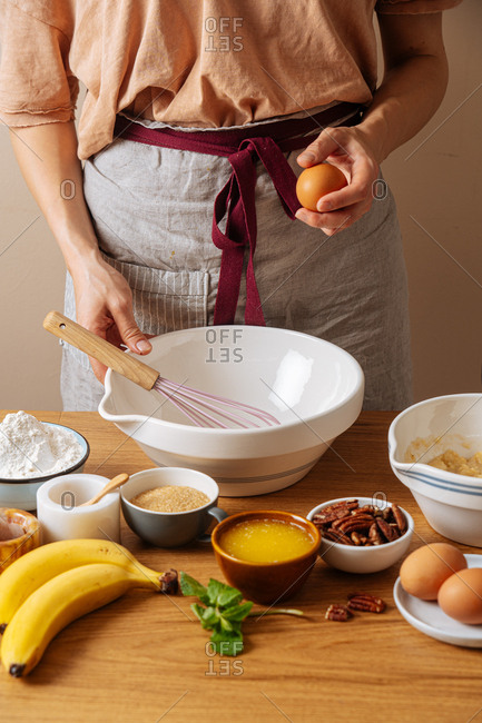Chef holding an egg while preparing a recipe