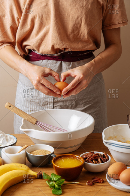 Chef breaking an egg while preparing a recipe