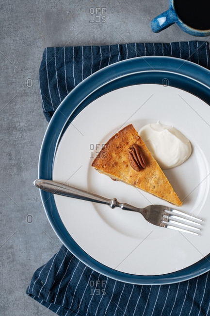 A slice of banana skillet cake served on a plate with coffee