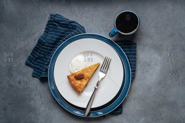 Slice of banana skillet cake served on a plate with coffee
