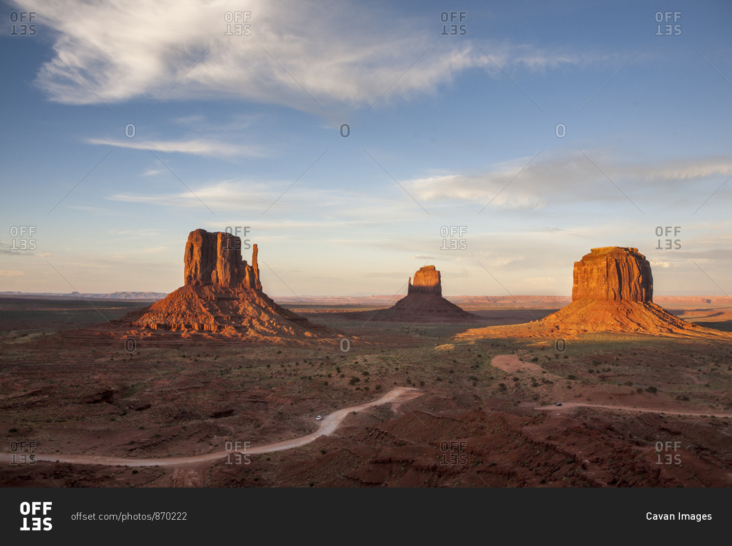 Sunset light hits the iconic rock formations in Monument Valley, AZ