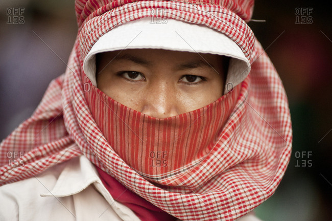 Cambodia, Phnom Penh, Phnom Penh - February 5, 2011: Young Cambodian lady uses checkered headscarf