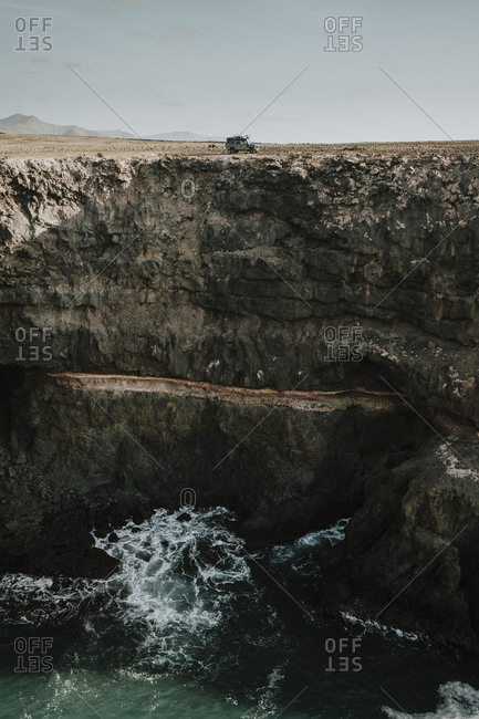 Overland adventure while driving a 4x4 close to the cliff