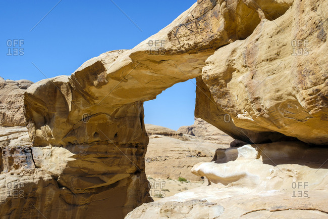 Natural stone bridge in wadi rum protected area, jordan