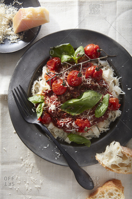 Pasta topped with tomatoes and basil