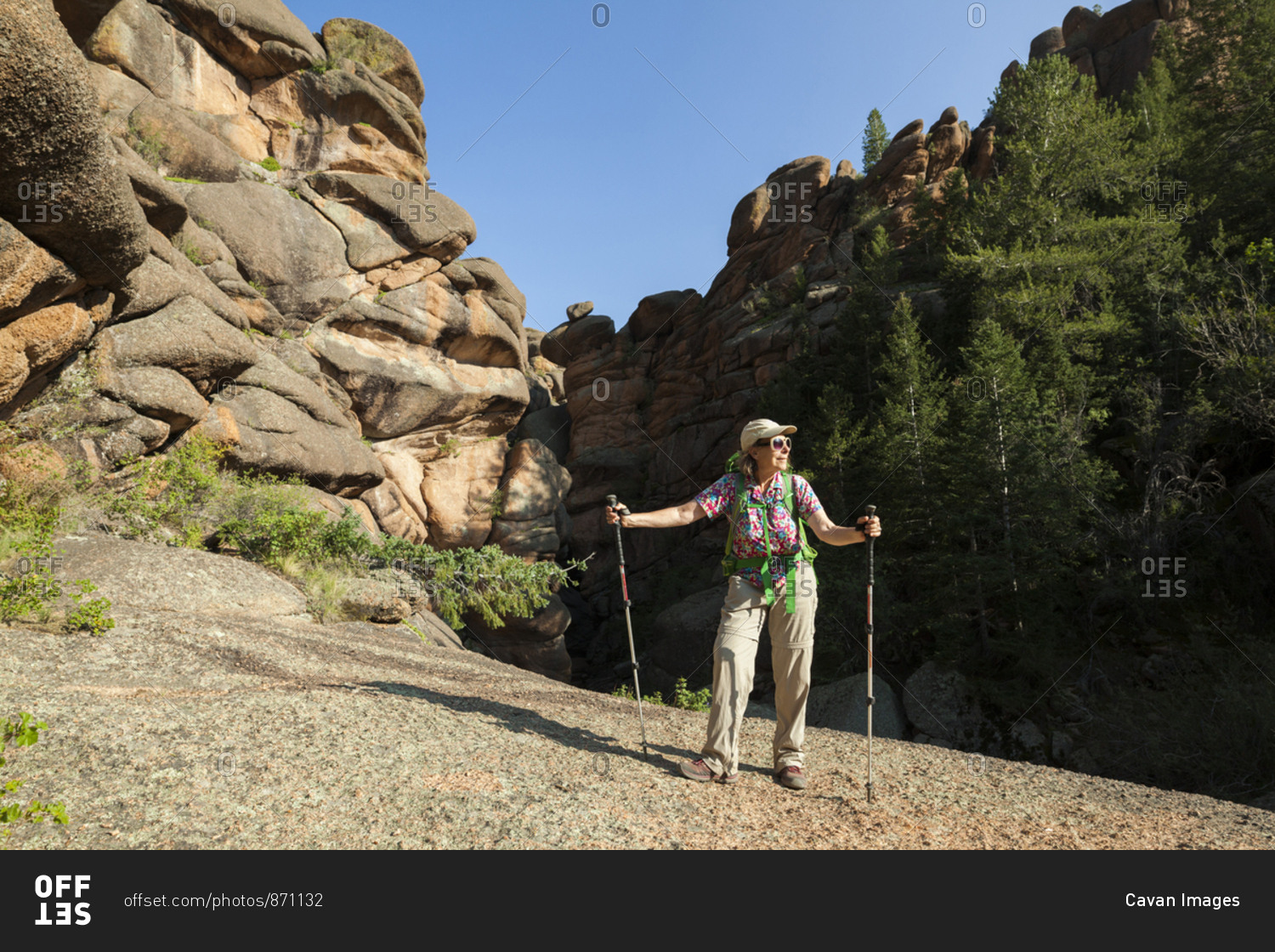 Senior woman hiker among rock formations in lost creek wilderness