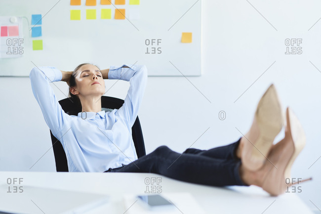 Closeup image of businesswoman resting feet under desk Stock Photo by  ©Kryzhov 193532346