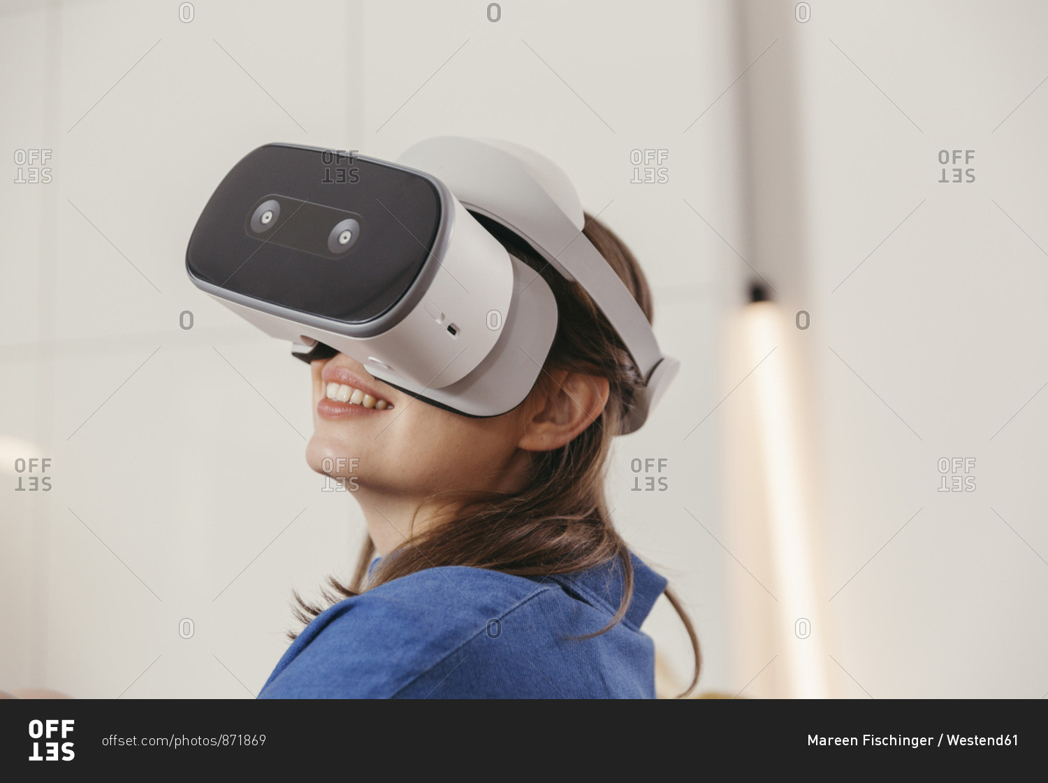 Young woman using VR glasses at home