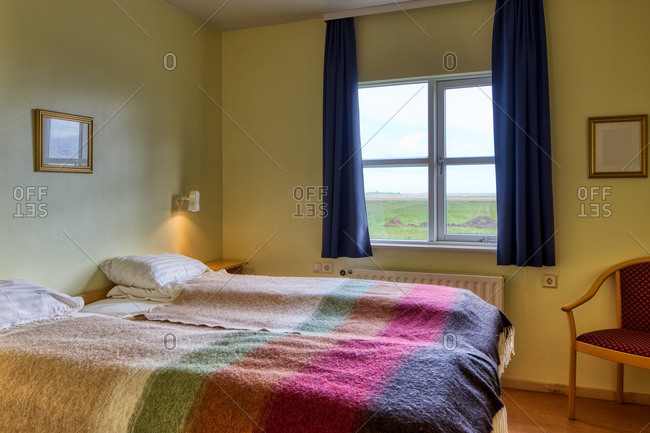 Two Neat Comfortable Beds With White Pillows And Warm Colorful Blankets In Light Cozy Room Yellow Walls Against Window Blue Curtains Overlooking Rural Landscape Stock Photo Offset