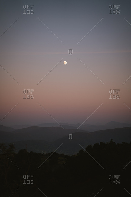 Moonrise over the mountains of basque country during twilight