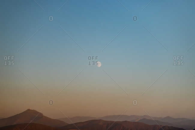 Moonrise over the mountains of basque country during twilight
