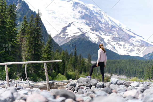 Woman hiker is thinking about hiking to the top of the mountain
