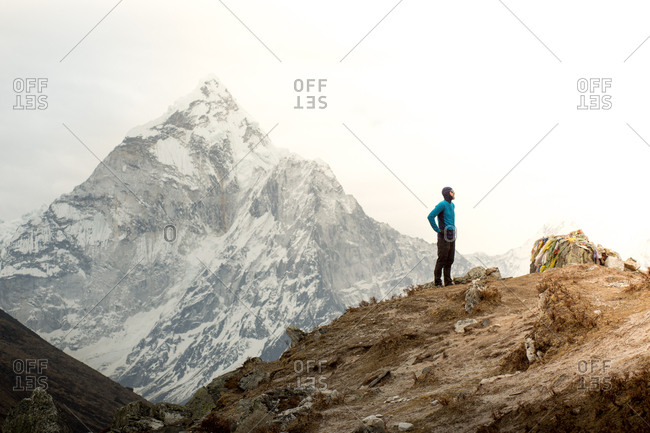 A man stands in front of Ama Dablam at the Everest Memorial Park.