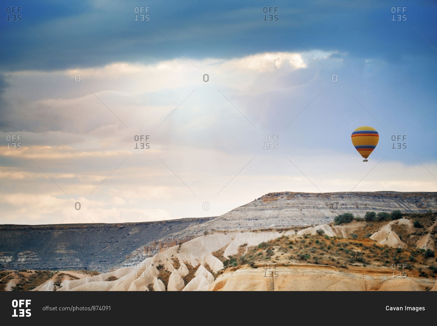 Hot air balloon flying over the rocks