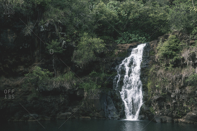 Scenic view of waterfall over rock formations