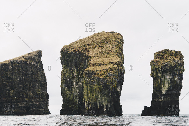 Scenic view of stack rocks in sea against sky