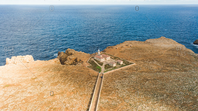 Aerial view of Punta Nati lighthouse at arid terrain, Balears Island, Spain.