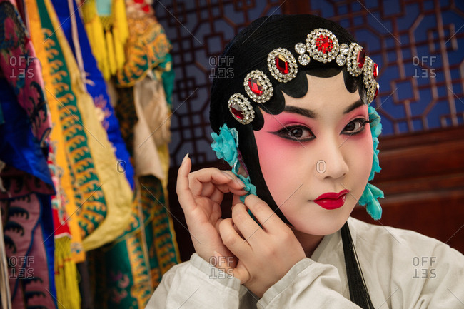 Female Peking Opera actor backstage makeup