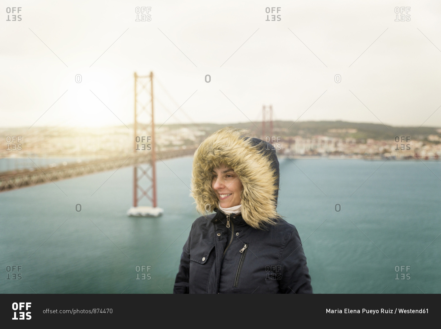Portugal- Lisbon- portrait of happy woman in front of Ponte 25 de Abril
