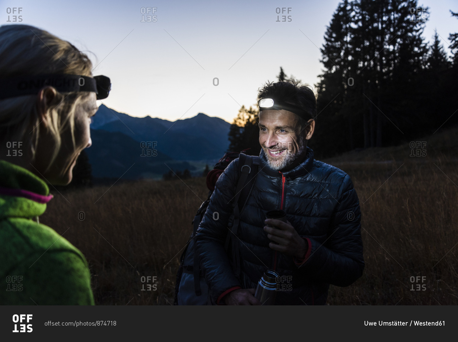 Couple hiking at night- wearing head lamps