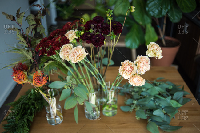 Detail photos of flower stems in water on table