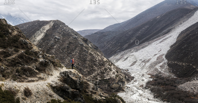Young woman trekking in the Himalayas near Dingboche- Solo Khumbi- Nepal