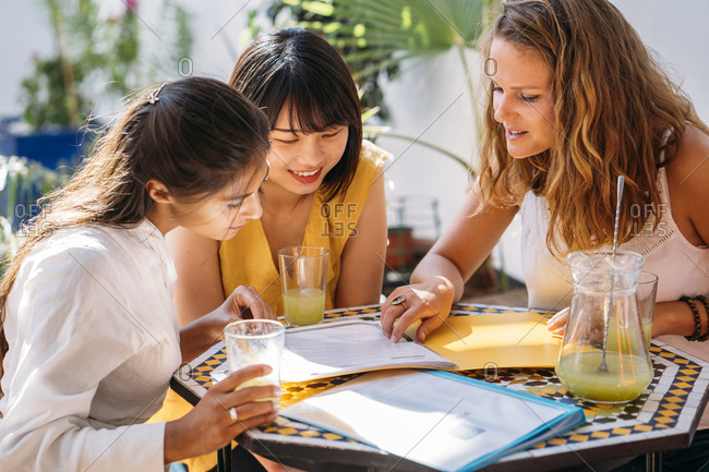 Female multicultural students meeting in a cafe