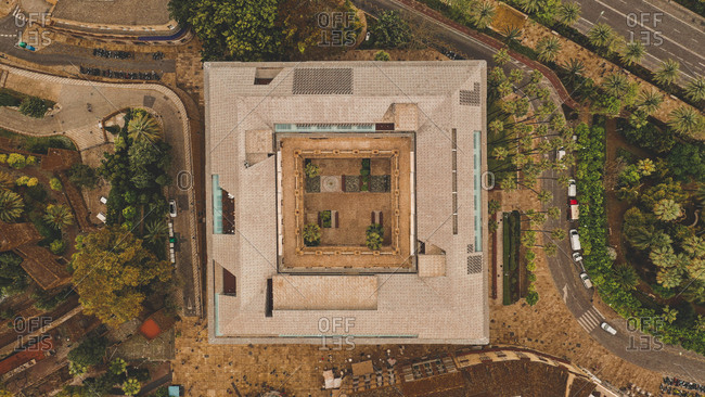 April 8, 2019: Aerial view of abstract beautiful rectangular house with patio surrounded by colorful green trees in Malaga, Spain