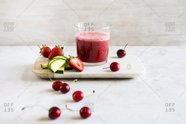 Delicious fruit and vegetable juice on a cutting board