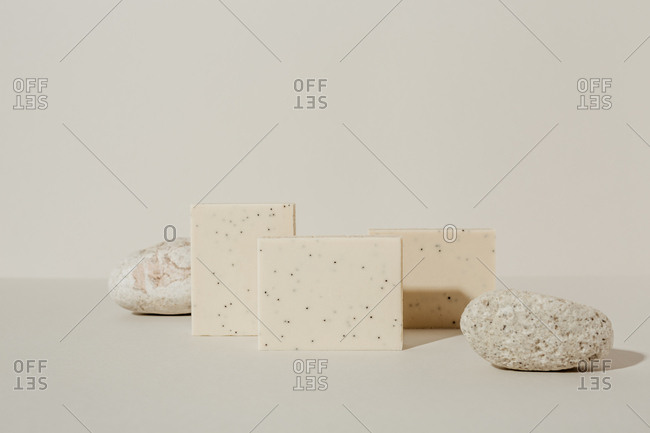 Soaps and stones on light background