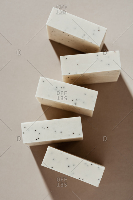 Handmade soaps arranged on beige background