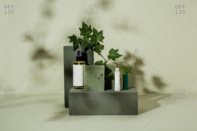 Natural green soap, lip balm, and oil with ivy leaves