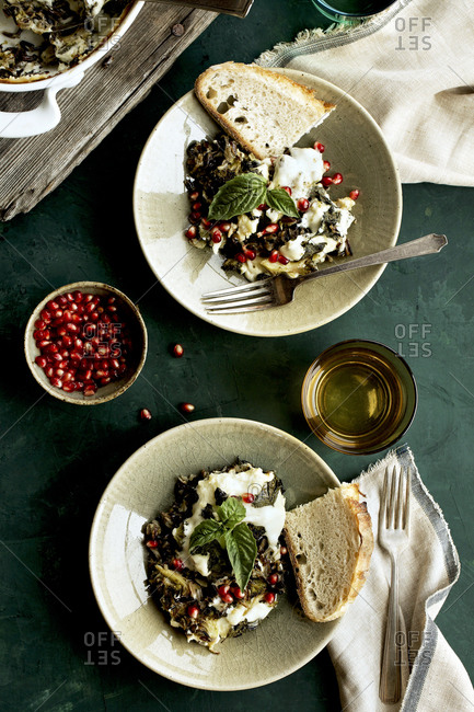 Cheesy broccoli wild rice casserole with crispy basil served with bread