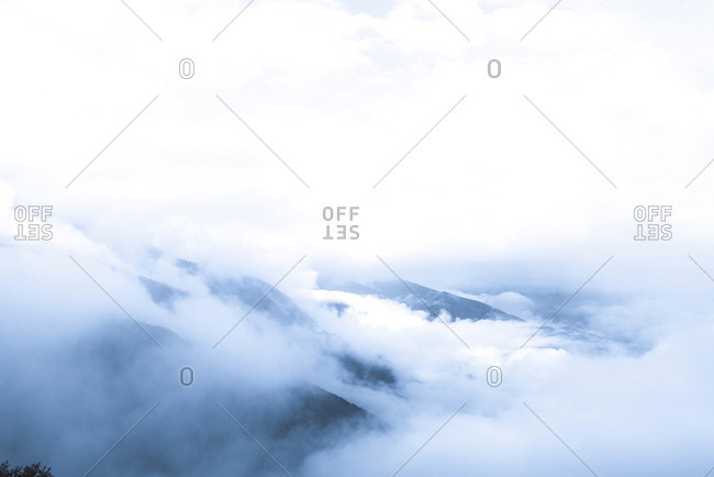 Scenic view of clouds covering rock formations