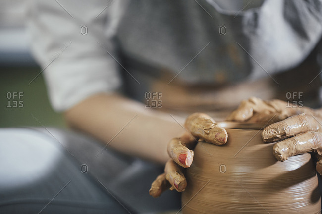 Hands molding clay in a pottery and ceramic studio in Chiang Mai, Thailand  stock photo - OFFSET
