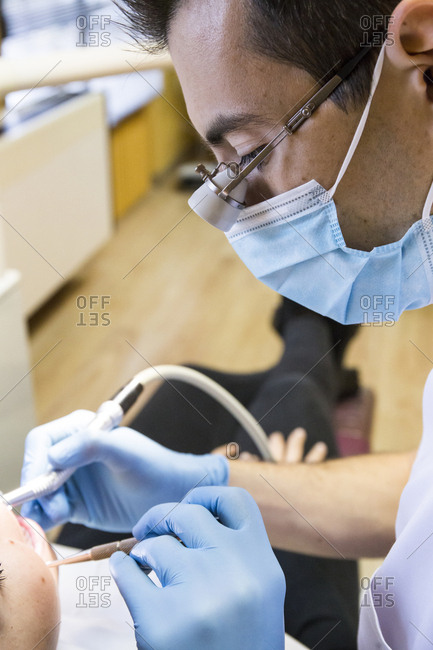 Close-up of dentist examining patient in clinic