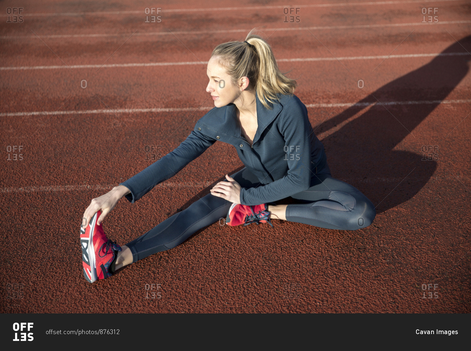 High angle view of female athlete exercising on sports track