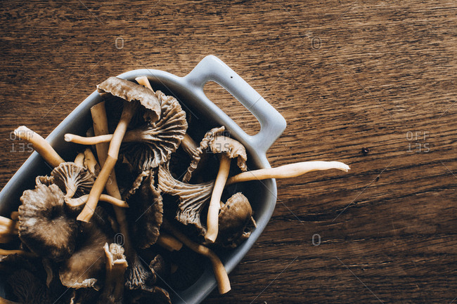 Close-up of mushrooms in container on wooden table