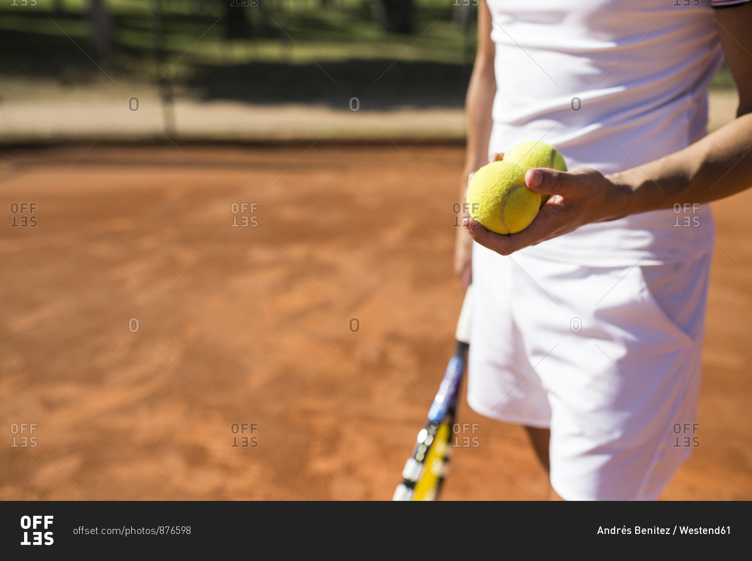 Man holding tennis balls during tennis match