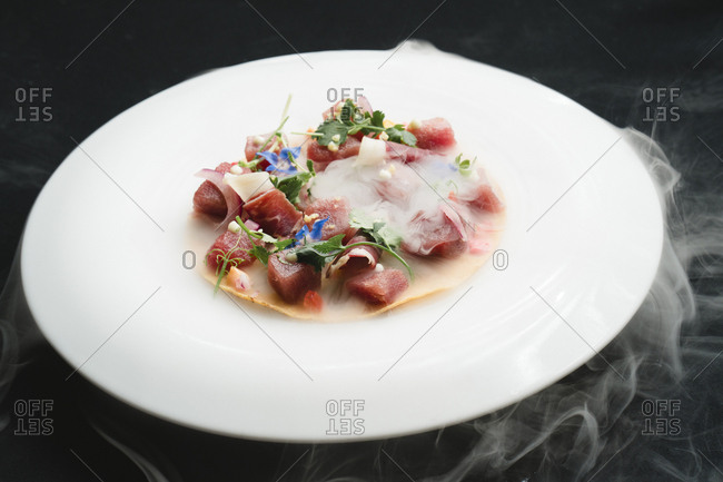 High angle view of steam emitting from food served in plate on table