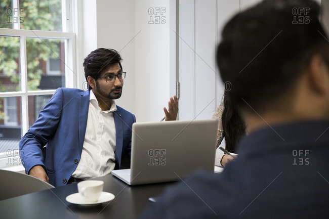 Business people during meeting at desk in office