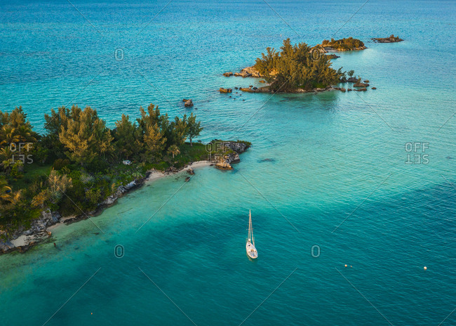 A yacht is near a tropical island in Bermuda