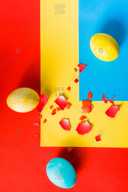 Colored egg over rainbow paper background