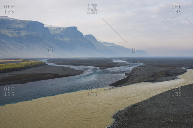 Scenic view of rivers by mountains against sky