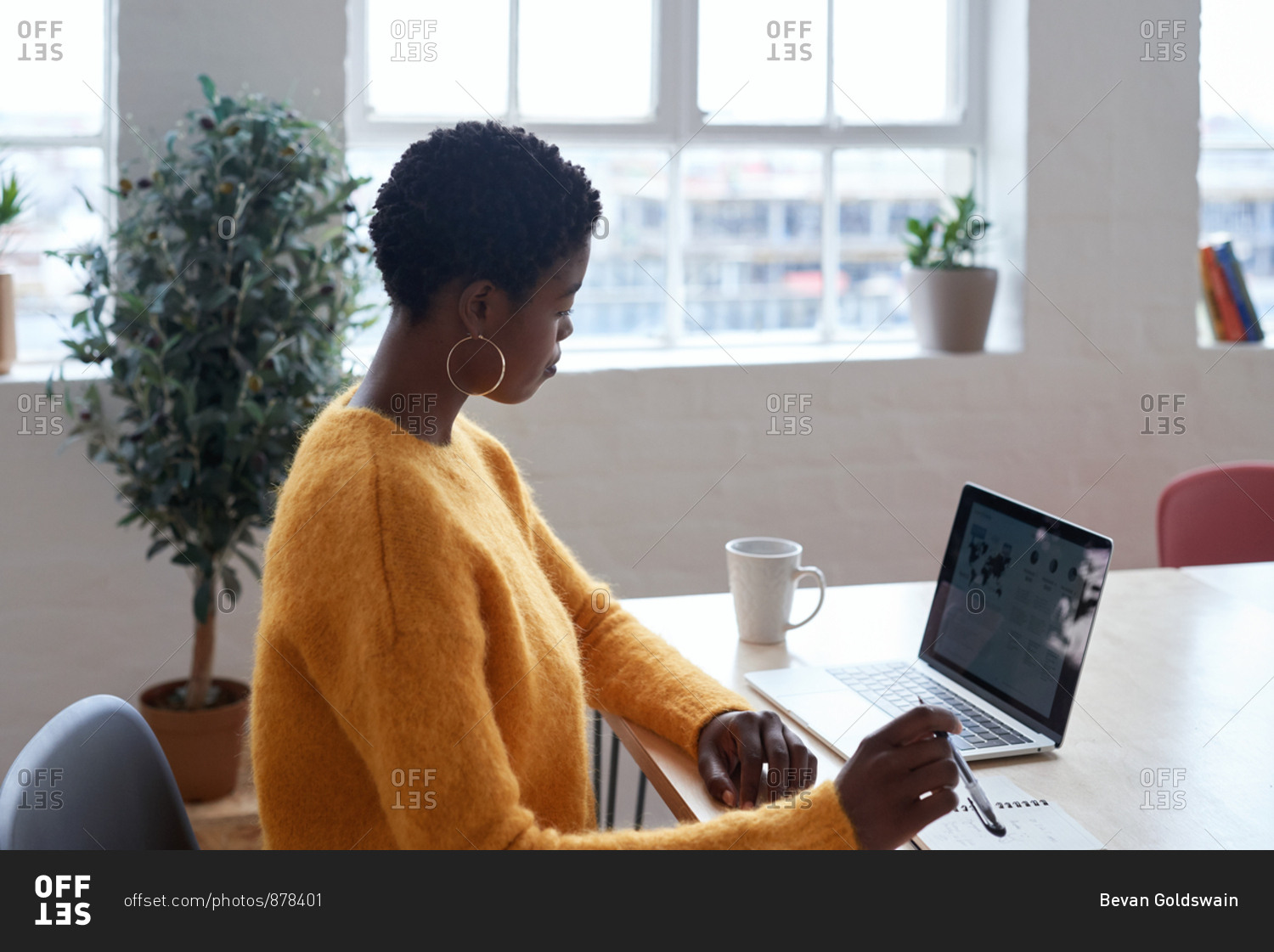 African Black Business Woman Using Smartphone While Working Laptop