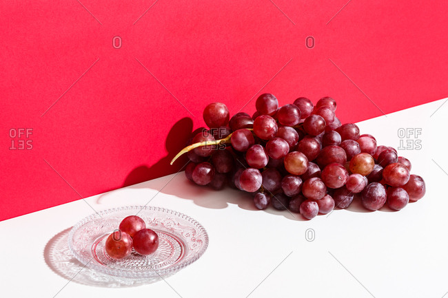 Cluster of red grapes on a white table